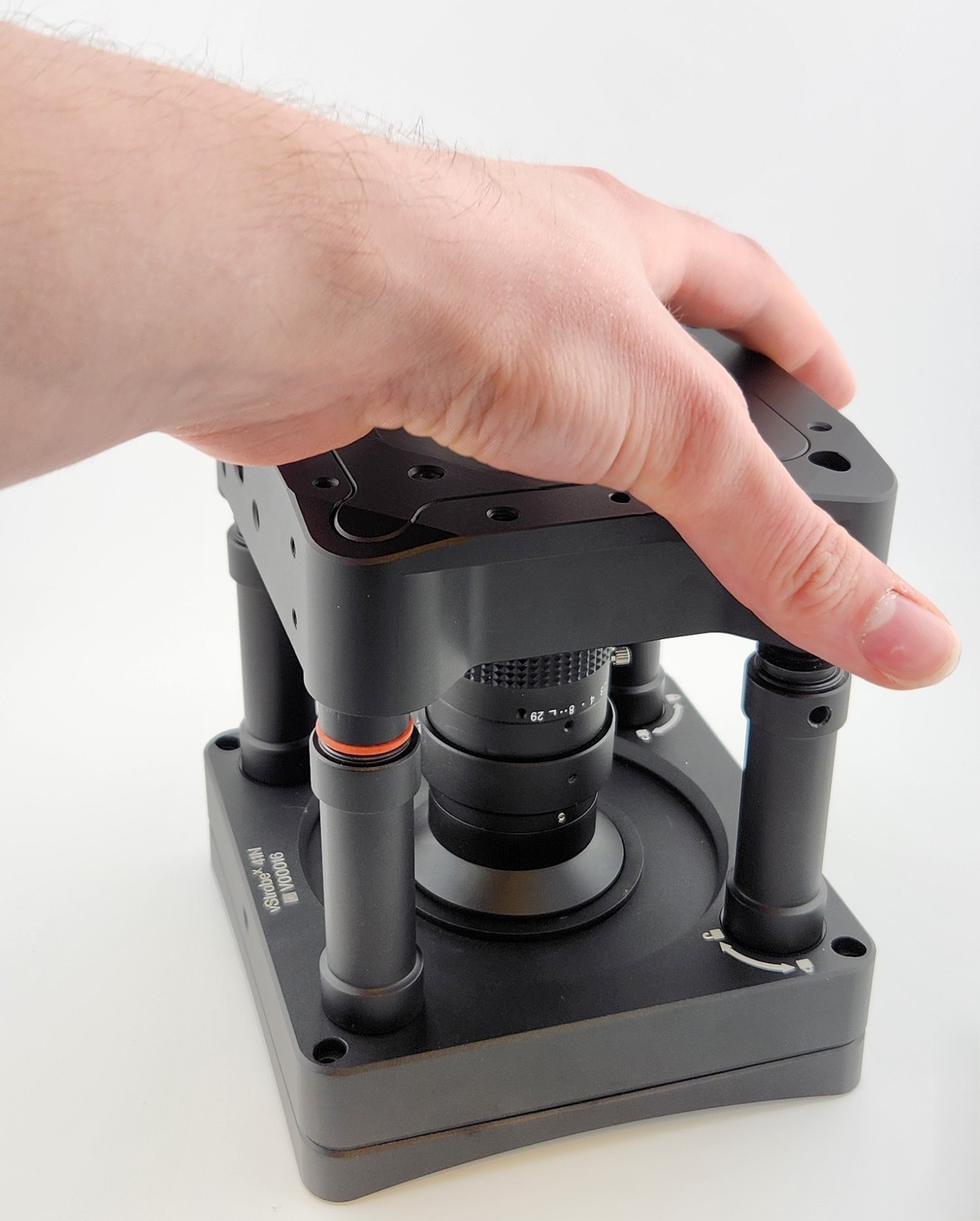 A photo of a hand setting the VersaX camera onto the Ring Light.