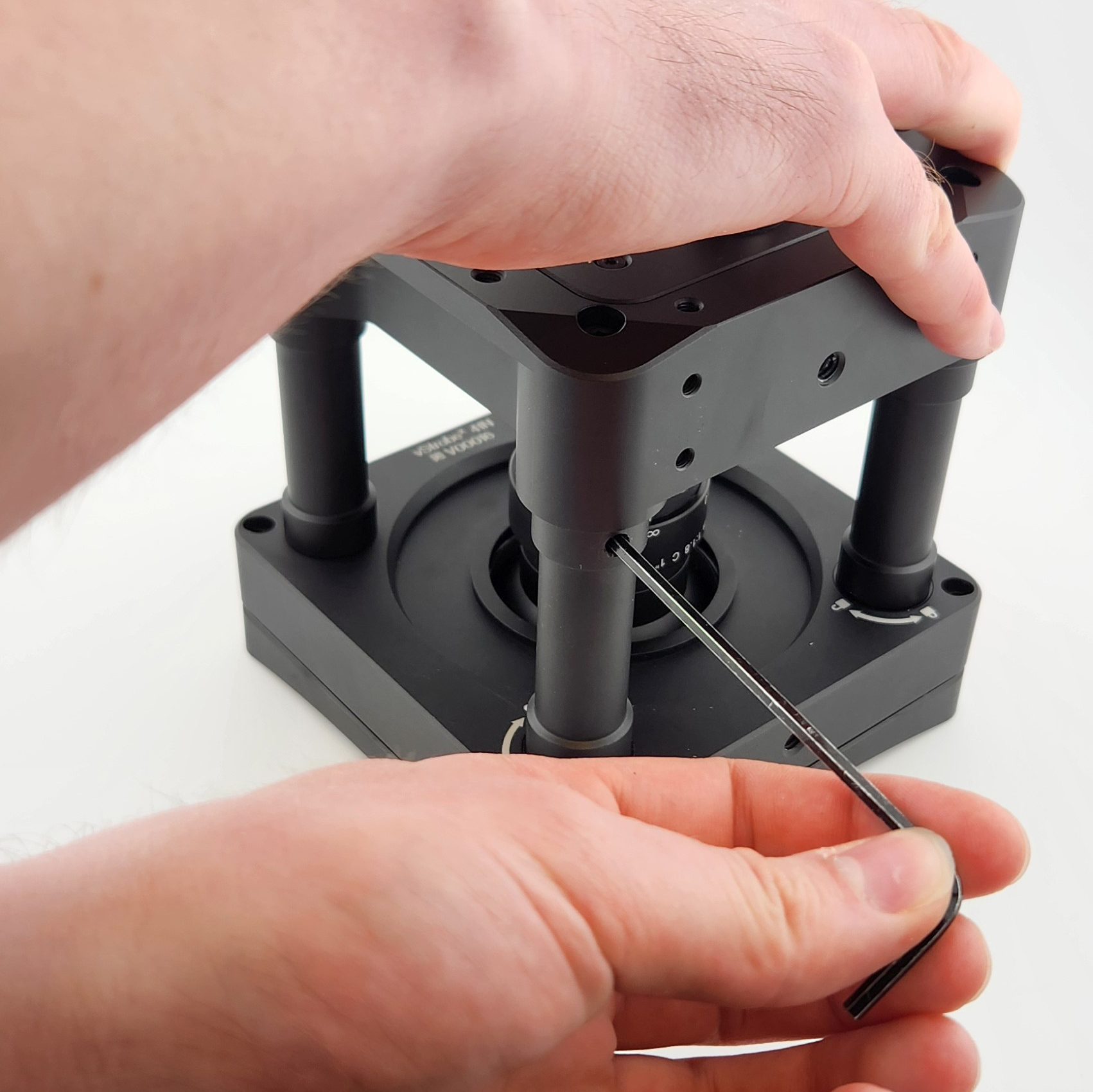 A photo of hands Locking a Post in Place with the Locking Tool.